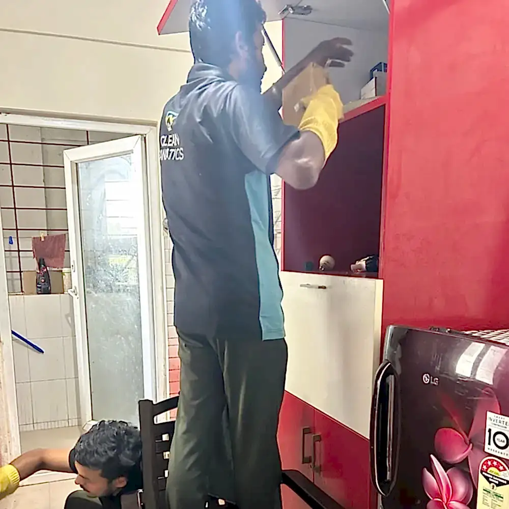Clean Fanatics - Book Professional Cleaning Services Bangalore Professional Cleaning Services Clean Fanatics staff cleaning kitchen cabinets.