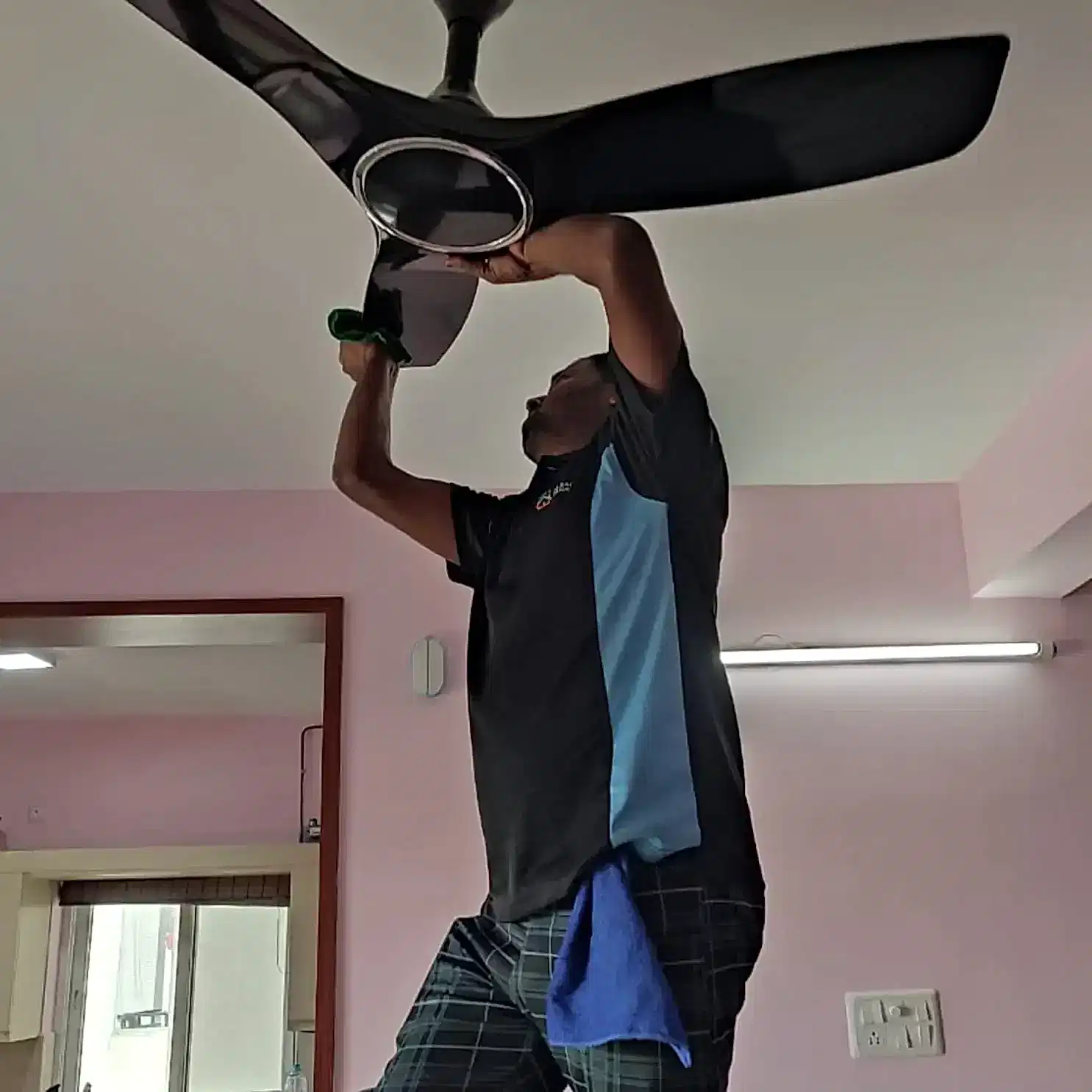 Clean Fanatics - Book Professional Cleaning Services Bangalore Professional Cleaning Services Clean Fanatics professional cleaning a ceiling fan during a full house cleaning service